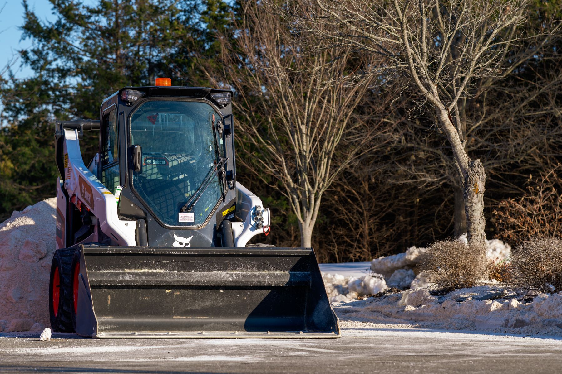 Skid steer clearing snow